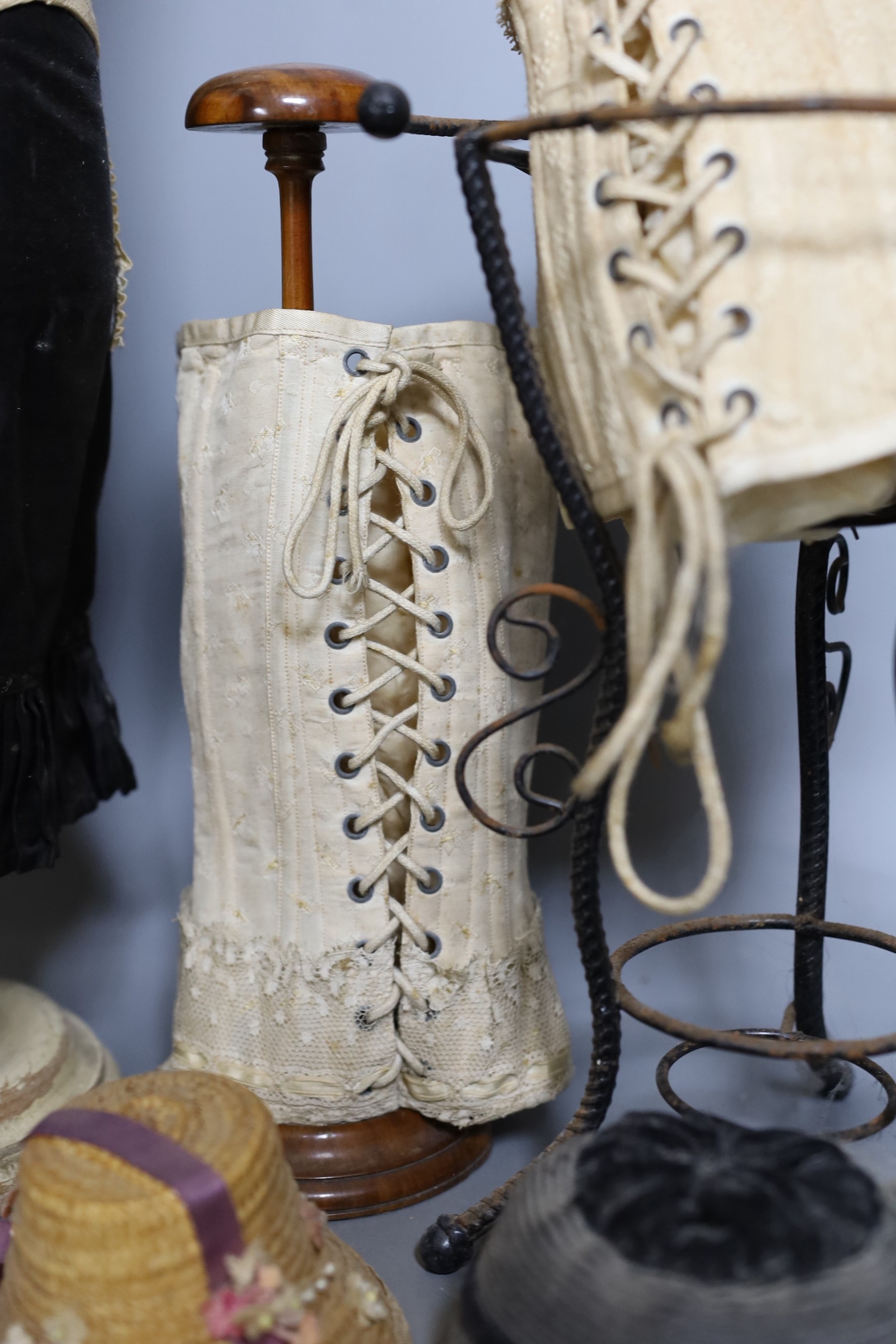 A 1920s/1930s ‘Sanetta’ shop display miniature corset dummy, 59 cm, three miniature corsets, a 1920s painted composition and metal thread decorated butterfly girl figure and other items